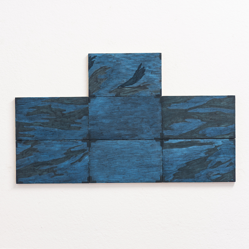 grey scale rectangular paintings on a white wall