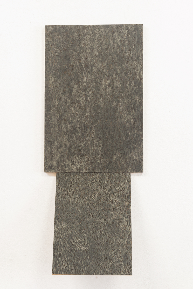 grey scale rectangular paintings on a white wall