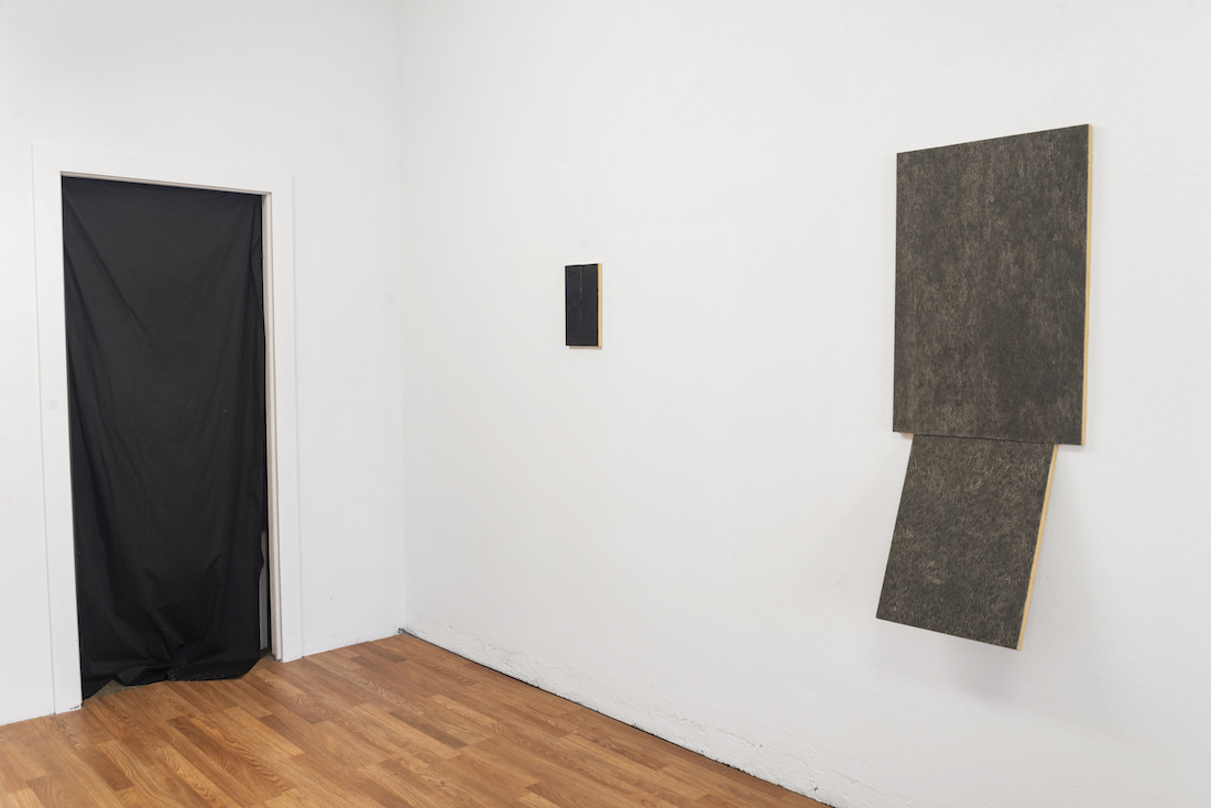 grey scale rectangular paintings on a white wall