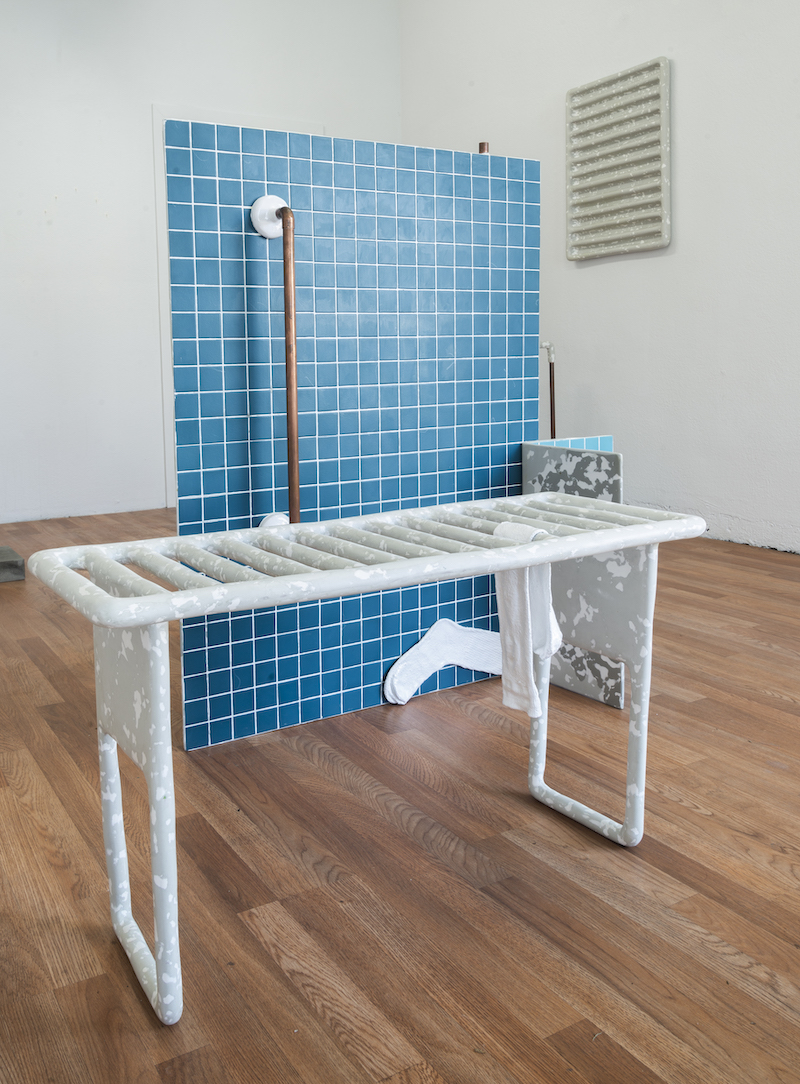 Blue tile corner sock sculpture and pipes