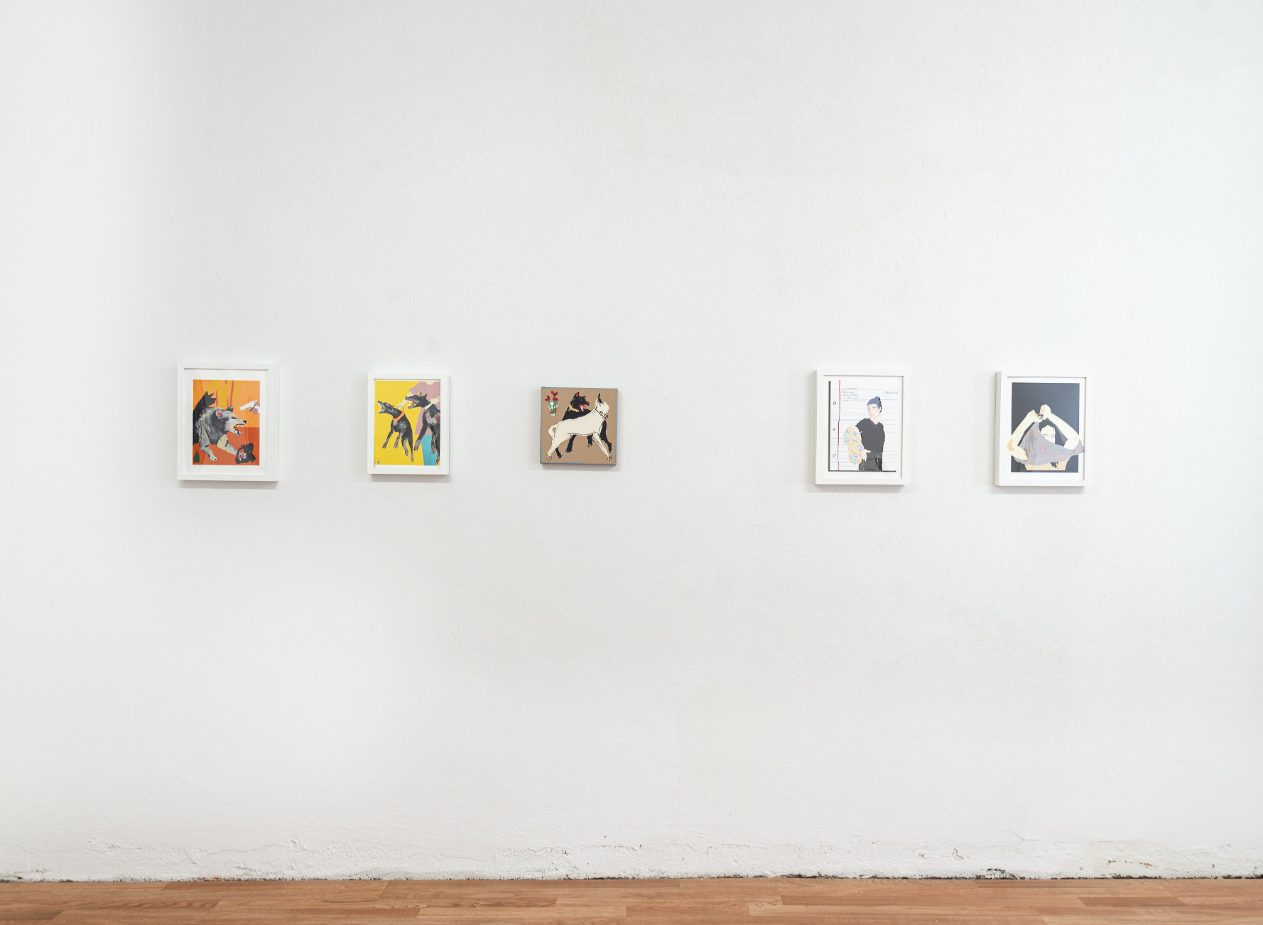 Indoor installation with white walls and wooden floor, small framed collages on the wall