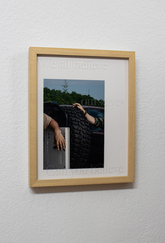 Installation shots of install. Framed pictures in small gallery white walls wood floors