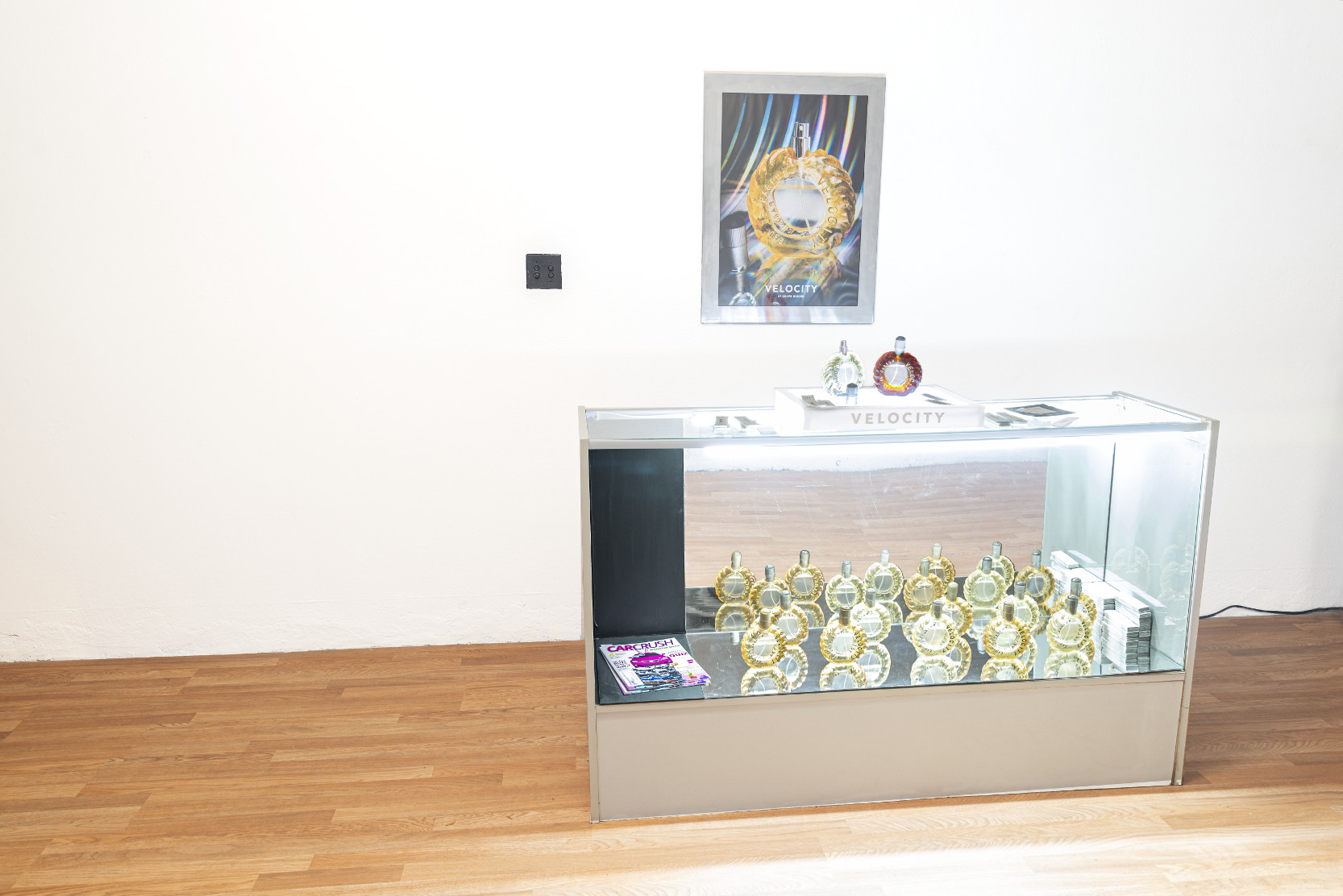 installation with glass case and perfume bottles